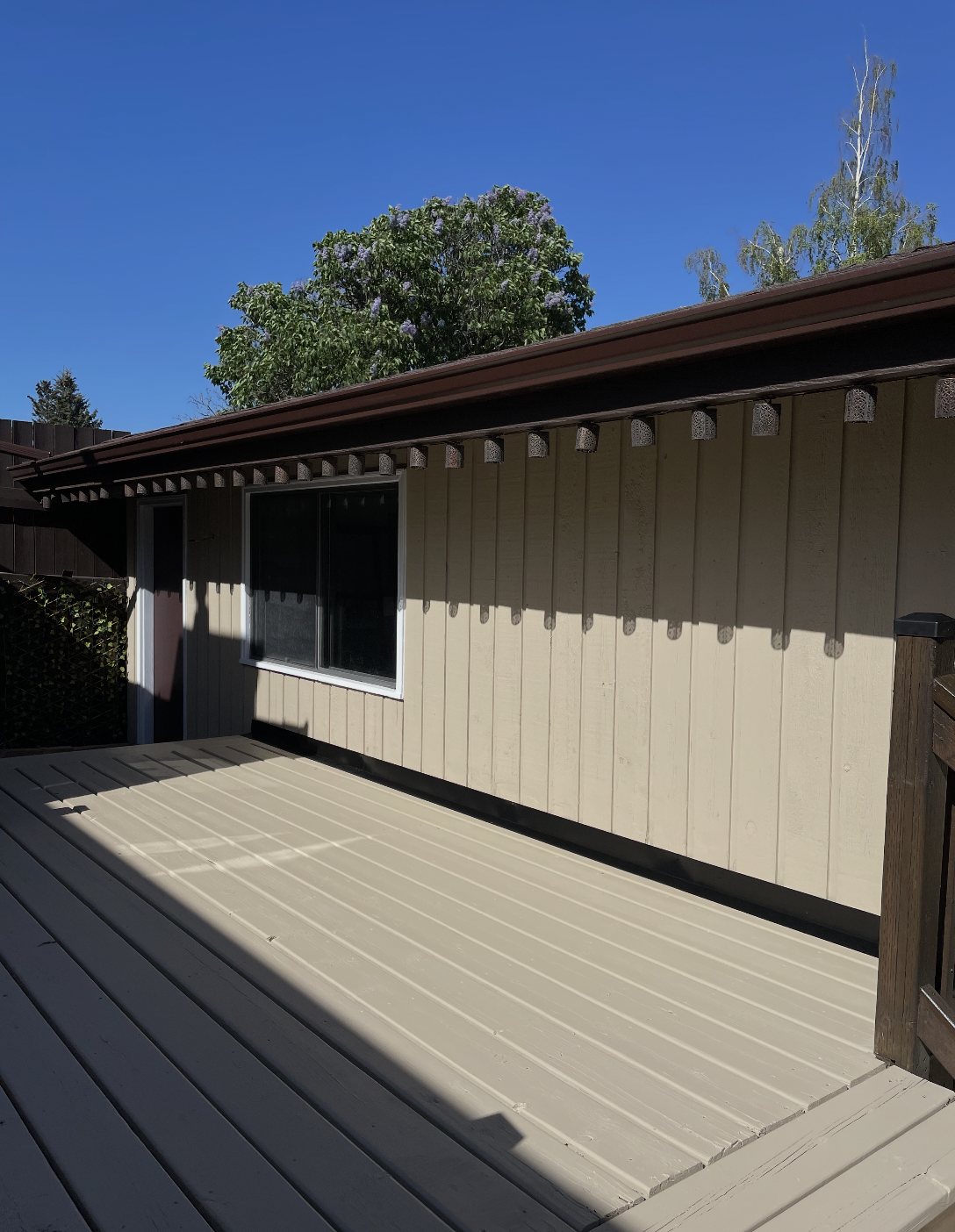 Same back deck and siding freshly painted in warm taupe by B&R Painting Calgary