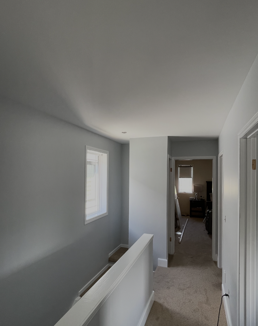 Same upstairs hallway with smooth ceiling and fresh light grey walls by B&R Painting Calgary