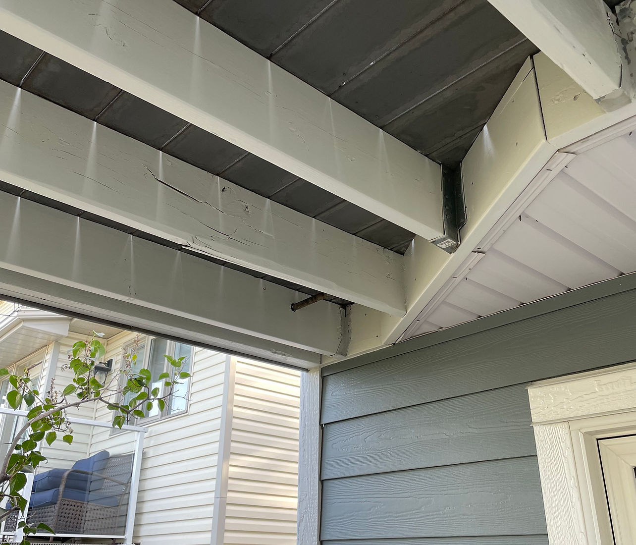 Same covered deck with beams painted clean white and soft sage by B&R Painting